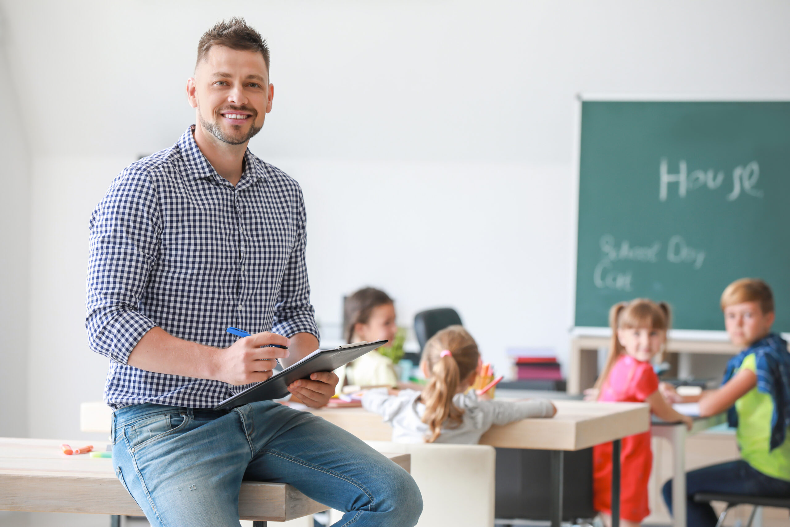 Portrait of male teacher in classroom